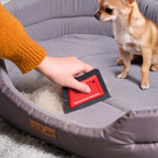 FurAway reusable pet hair remover lifting fur from a gray dog bed